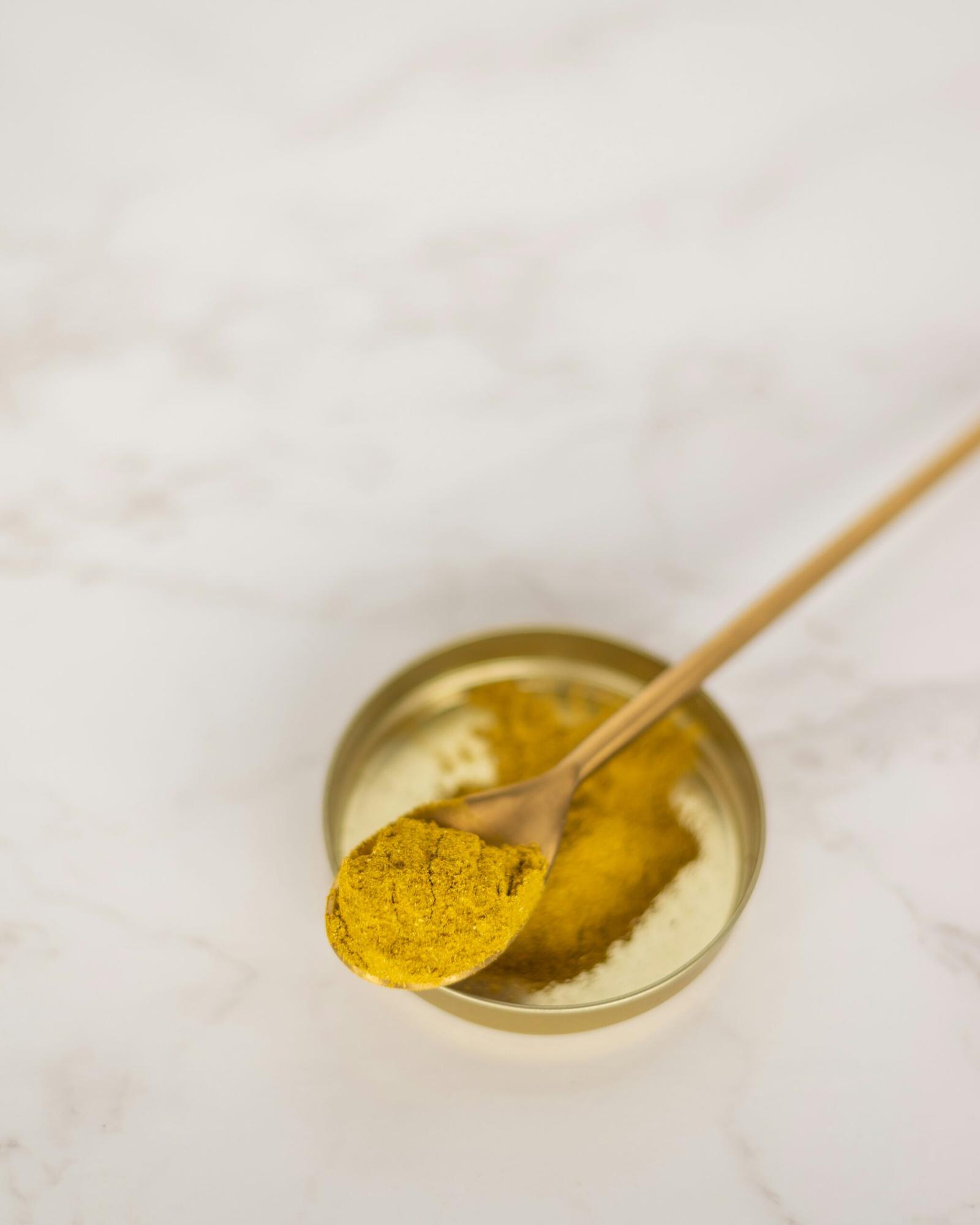 Discover the Amazing Benefits of Turmeric and Curcumin 1 stainless steel spoon on clear glass bowl